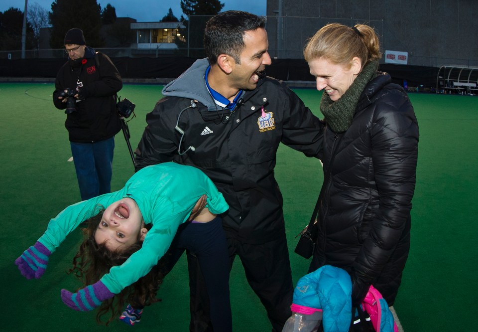 University of British Columbia Thunderbird Head Coach Robin D'Abreo celebrates with his family following a 3-2 victory (3-1 in penalty shots) over the University of Victoria Vikes in the gold medal match of the CIS Women's Field Hockey Championships claiming their fifth straight McCrae Cup on November 8th, 2015 in Victoria, British Columbia, Canada.