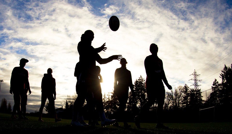 Karen Paquin tosses a rugby ball into the air prior to the start of a team practice at the Pacific Institute for Sports Excellence in Victoria, British Columbia Canada on January 25, 2016. (Kevin Light/CBCSports)