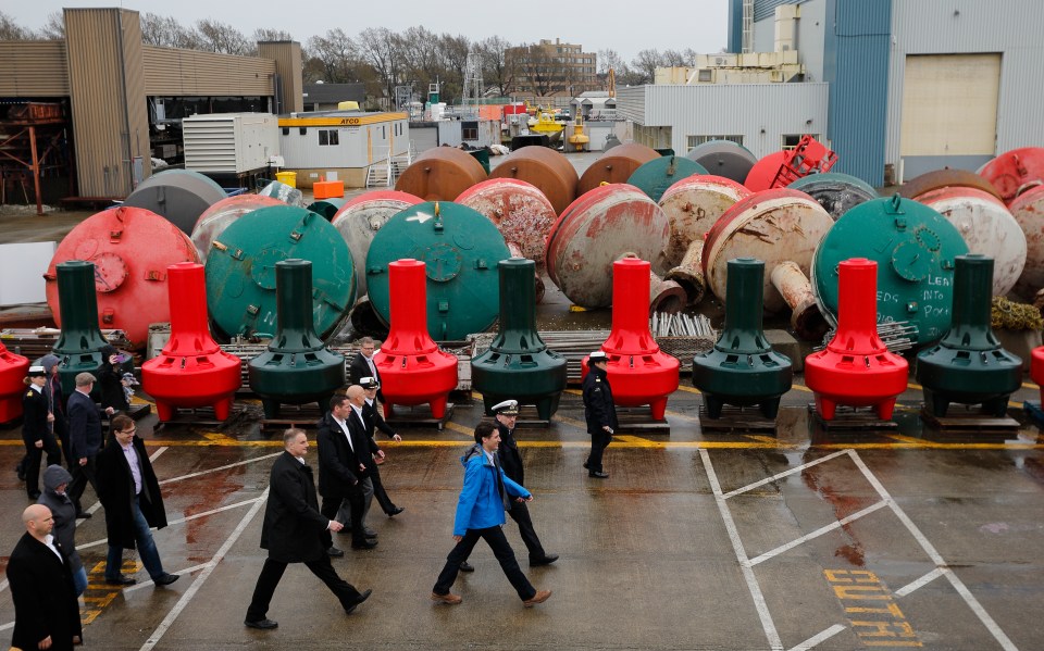 Canada's Prime Minister Justin Trudeau, walks along the dock past port hand and starboard hand navigation buoys prior to meeting with Canadian coast guard workers in Victoria